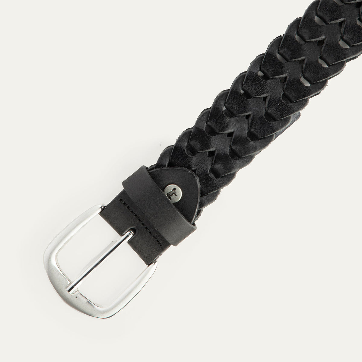 Close-up angled view of the black woven leather W Link belt showing the brushed silver buckle and braided texture