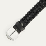 Close-up angled view of the black woven leather W Link belt showing the brushed silver buckle and braided texture