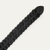 Close-up of the black woven leather W Link belt's pointed tail end and interlocking braid pattern