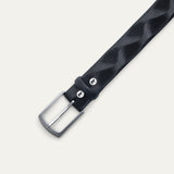 Close-up of the Will Leather Goods Wave Embossed Belt in black, showing the brushed silver buckle, keeper loop with embossed dog logo snap, and wave-textured leather.