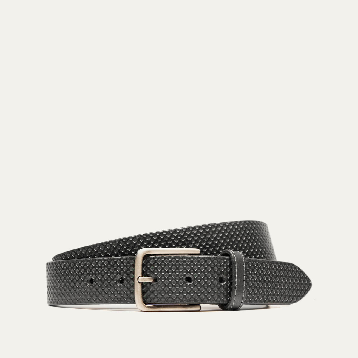 Black leather belt with a small diamond-embossed texture and a brushed silver buckle, coiled view.