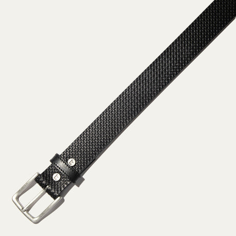 Close-up of the black diamond-embossed leather belt strap showing the textured pattern and keeper loop.