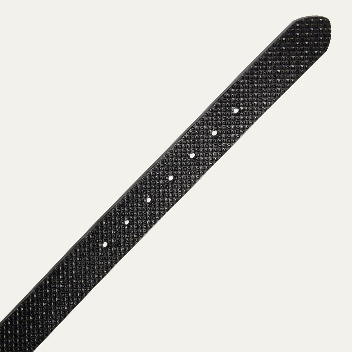 Close-up of the black diamond-embossed leather belt strap tip end with adjustment holes.