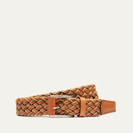 Tan leather and waxed cord braided belt coiled to show the brushed nickel buckle and woven texture