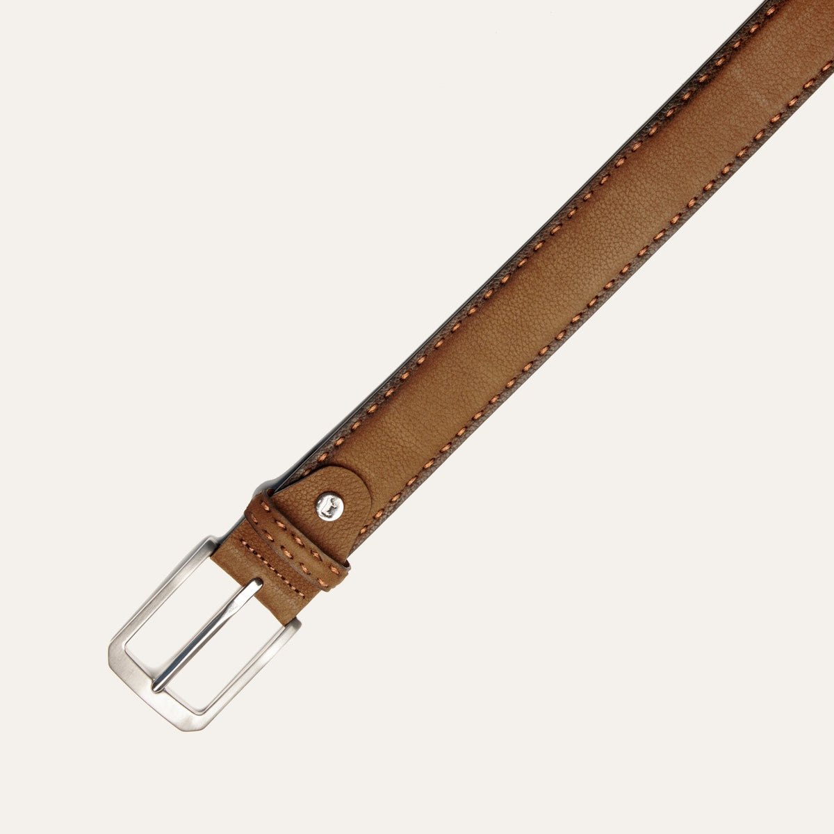 Close-up of the cognac nubuck belt's buckle and contrast stitching