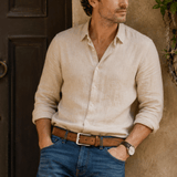 Lifestyle photo of a man in a linen shirt and jeans wearing the cognac nubuck belt
