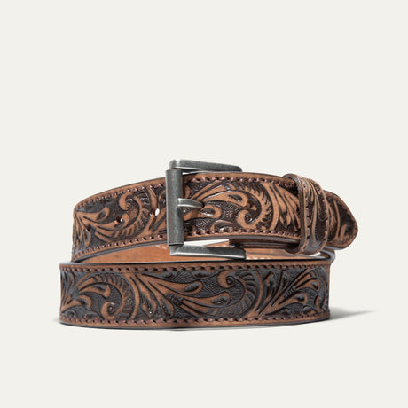 Hand-Tooled Morning Glory Jean Belt by WILL Leather Goods in antiqued brown leather with a hand-tooled floral pattern and antique nickel buckle, coiled front product view on a white background.