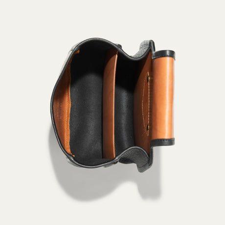 Will Leather Goods Ammo Belt Bag with flap open, showing the black suede-lined interior with a tan leather divider pocket and snap closure.