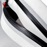 Extreme close-up of the black airtight zipper running along a white TILLIV Compak pack