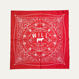 Will's Bandana in red paisley print, laid flat showing the center WILL Leather Goods cattle-brand logo, on a white background.