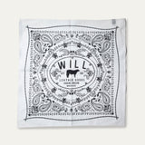 Will's Bandana in white with black paisley print, laid flat showing the center WILL Leather Goods cattle-brand logo, on a white background.