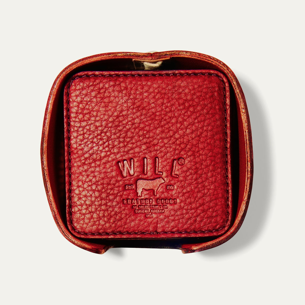 Open round leather holder for the Set of Eight Coasters in red pebbled leather, showing the embossed WILL logo, on a white background.
