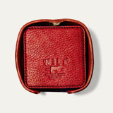 Open round leather holder for the Set of Eight Coasters in red pebbled leather, showing the embossed WILL logo, on a white background.