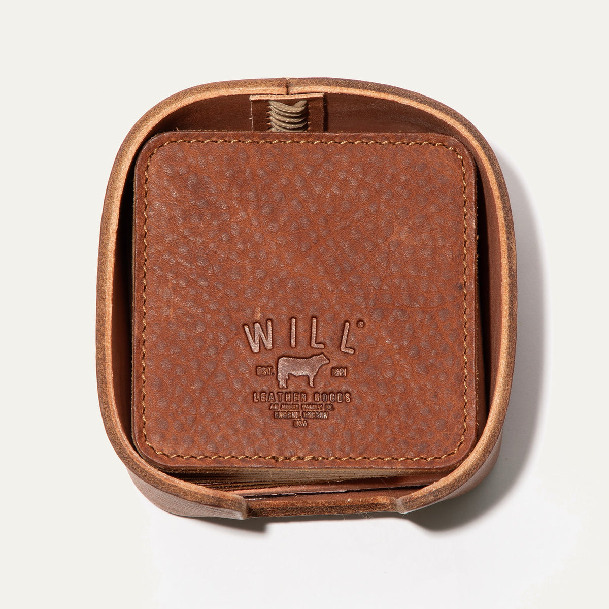 Open round leather holder for the Set of Eight Coasters in tan pebbled leather, showing the embossed WILL logo, on a white background.