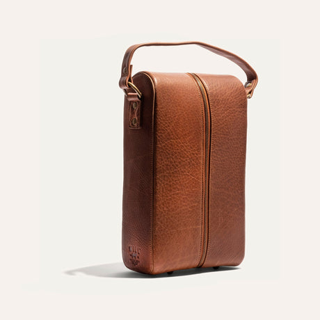 Will Leather Goods Hard Double Leather Wine Case in tan pebbled leather, three-quarter angled view showing the carry handle, zipper pull, and embossed WILL logo patch.