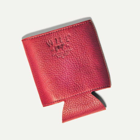 Will Leather Goods Leather Bottle & Can Holder in red leather, empty koozie shown at an angle with the embossed WILL cattle-brand logo, on a white background.