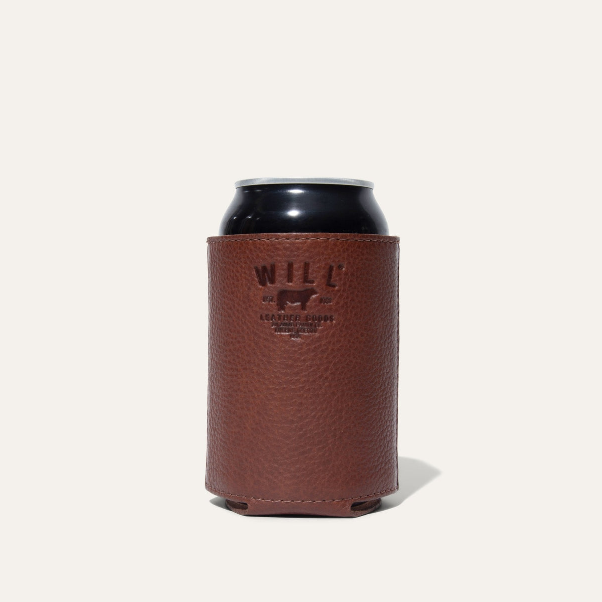 Cognac leather can holder with a can inserted, embossed WILL Leather Goods logo facing forward, on a white background.