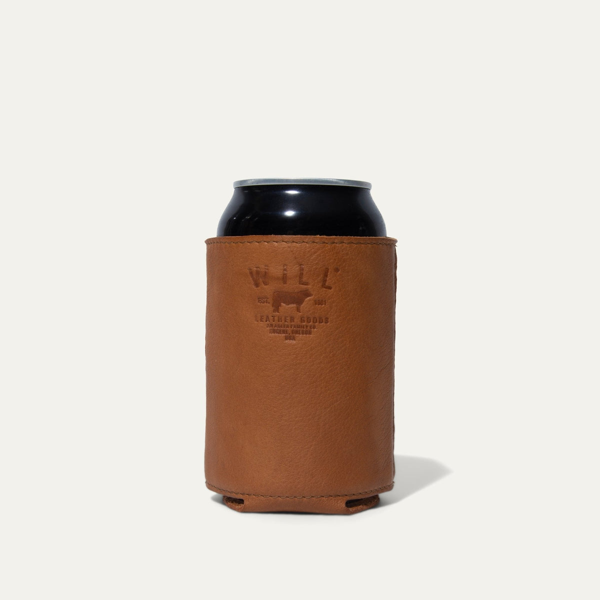 Tan leather can holder with a can inserted, embossed WILL Leather Goods logo facing forward, on a white background.
