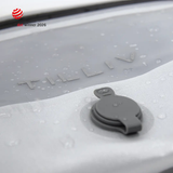 Water beading on the surface of a white TILLIV Compak pack beside its one-way valve, showing the water-resistant coating