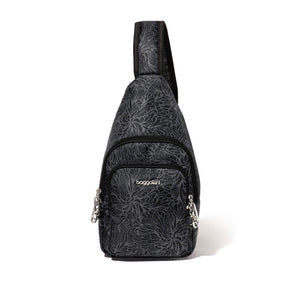 Baggallini Securtex Anti-Theft Daytripper Sling in a dark gray floral print with black trim, front product view of the teardrop-shaped crossbody sling showing the front zippered pocket, adjustable strap, and silver clasp hardware, on a white background.