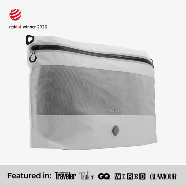 TILLIV Compak Large in Digital White seen at an angle, above a strip reading Featured in Conde Nast Traveler, Tatler, GQ, WIRED and GLAMOUR
