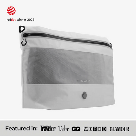 TILLIV Compak Large in Digital White seen at an angle, above a strip reading Featured in Conde Nast Traveler, Tatler, GQ, WIRED and GLAMOUR