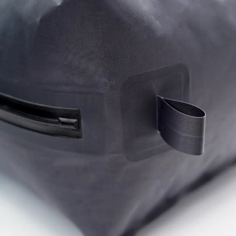 Close-up of a TILLIV Kamper corner showing the flat webbing anchor loop and the airtight zipper