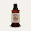 Will Leather Goods All-In-One Leather Solution, 8oz amber glass bottle with black cap and cream label reading Clean, Protect & Condition, Made in USA, studio shot on a white background.