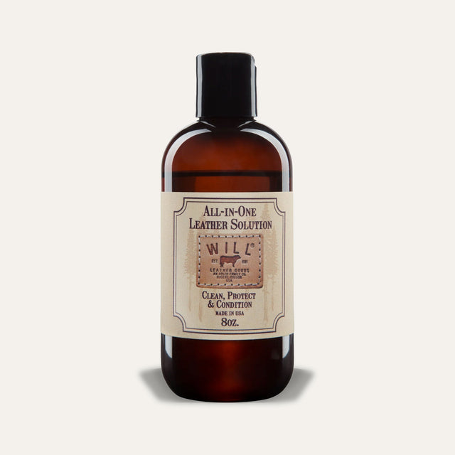 Will Leather Goods All-In-One Leather Solution, 8oz amber glass bottle with black cap and cream label reading Clean, Protect & Condition, Made in USA, studio shot on a white background.