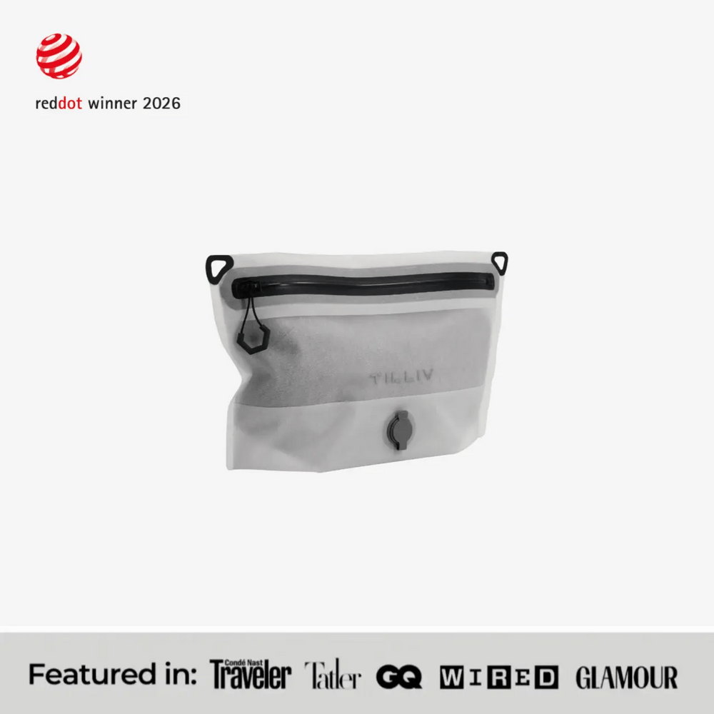 TILLIV Compak Small in Digital White, part-filled and seen at an angle, above a strip reading Featured in Conde Nast Traveler, Tatler, GQ, WIRED and GLAMOUR