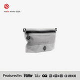 TILLIV Compak Small in Digital White, part-filled and seen at an angle, above a strip reading Featured in Conde Nast Traveler, Tatler, GQ, WIRED and GLAMOUR